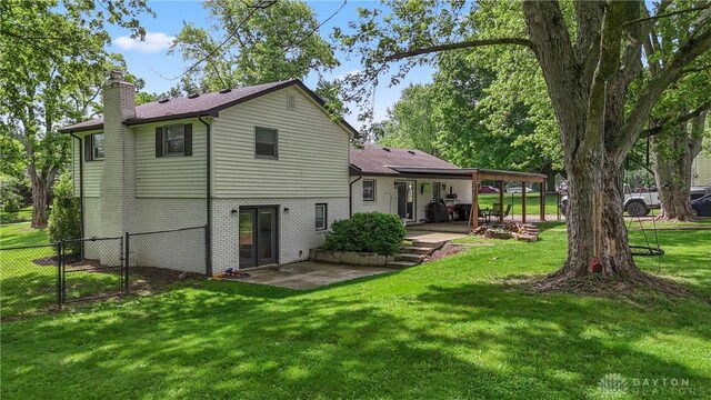559 Stover Rd, West Alexandria, OH 45381 - back of house with a patio, a chimney, brick siding, and a gate