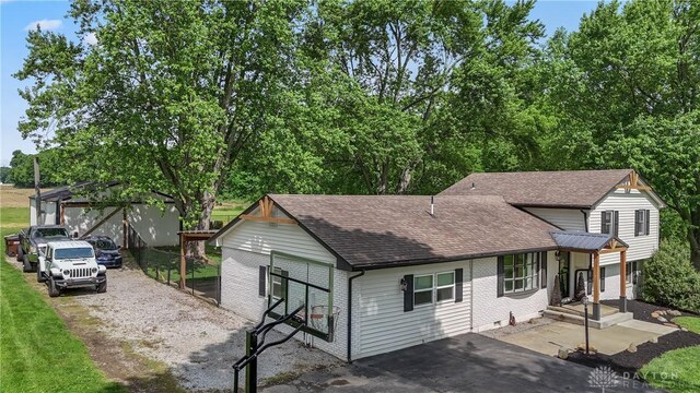 559 Stover Rd, West Alexandria, OH 45381 - view of front of property with a shingled roof, driveway, and brick siding