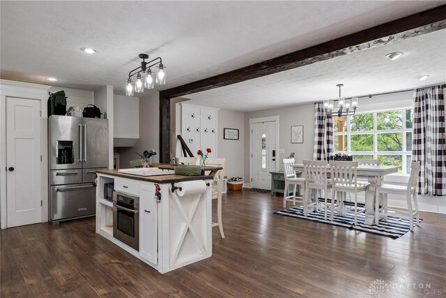559 Stover Rd, West Alexandria, OH 45381 - kitchen featuring appliances with stainless steel finishes, a chandelier, white cabinets, dark wood-type flooring, and recessed lighting