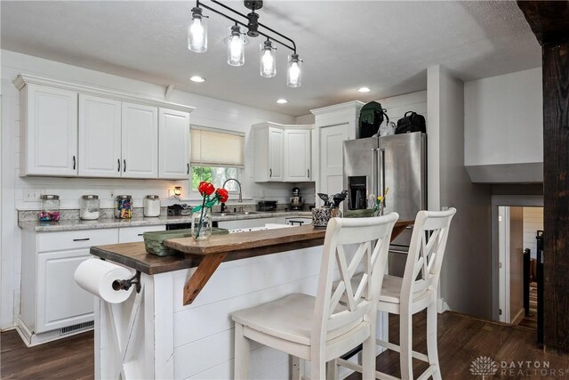 559 Stover Rd, West Alexandria, OH 45381 - kitchen with white cabinetry, stainless steel refrigerator with ice dispenser, dark wood-style flooring, and recessed lighting