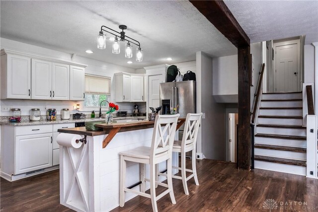 559 Stover Rd, West Alexandria, OH 45381 - kitchen with wooden counters, dark wood-style floors, white cabinetry, recessed lighting, and a center island