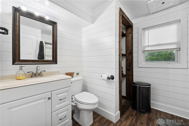 559 Stover Rd, West Alexandria, OH 45381 - bathroom with wood finished floors, vanity, toilet, wood walls, and baseboards