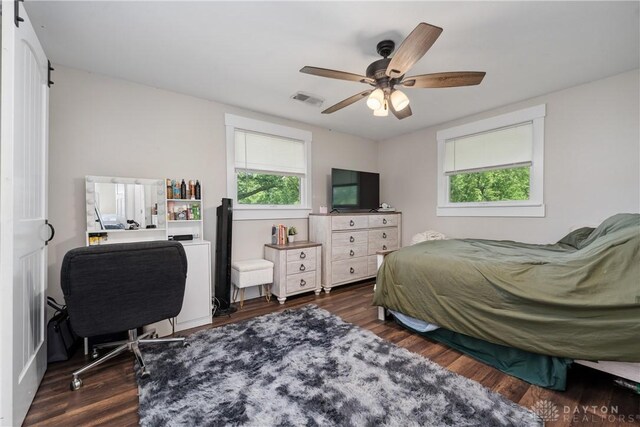 559 Stover Rd, West Alexandria, OH 45381 - bedroom with multiple windows, dark wood-style flooring, and ceiling fan