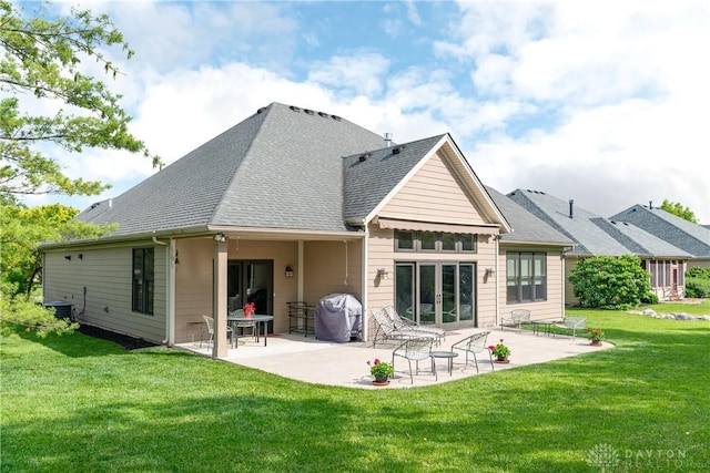 197 Harbour Dr, Springboro, OH 45066 - rear view of house featuring a lawn, a patio area, a shingled roof, and central AC unit