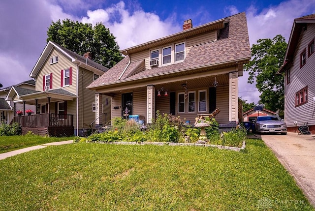 2057 Rugby Rd, Dayton, OH 45406 - view of front of house featuring a porch, a front lawn, a chimney, and roof with shingles