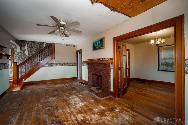 2057 Rugby Rd, Dayton, OH 45406 - unfurnished living room featuring wood-type flooring, stairs, a ceiling fan, a brick fireplace, and a chandelier
