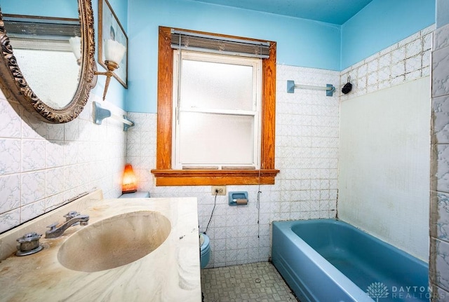 2057 Rugby Rd, Dayton, OH 45406 - full bath with tile walls, a bathtub, and vanity