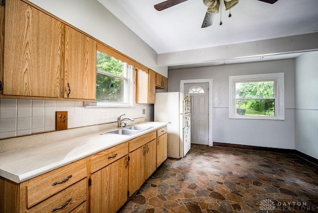 2057 Rugby Rd, Dayton, OH 45406 - kitchen featuring dark stone finish floors, freestanding refrigerator, backsplash, and light countertops