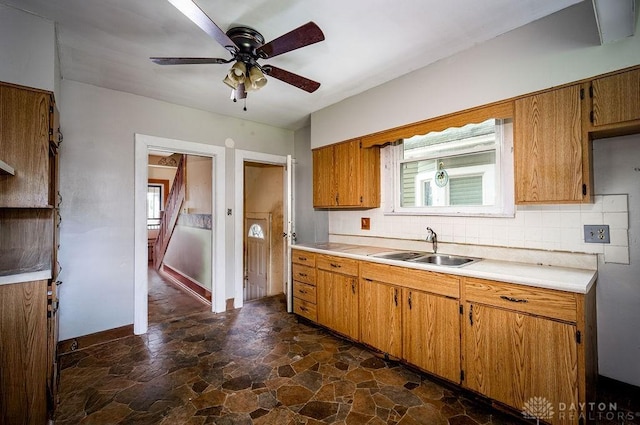 2057 Rugby Rd, Dayton, OH 45406 - kitchen featuring brown cabinetry, light countertops, dark stone finish flooring, and a ceiling fan