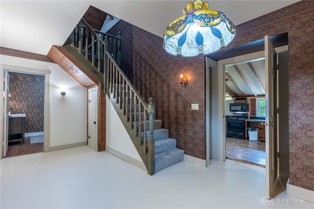 9891 Sugar St, Germantown, OH 45327 - staircase with wallpapered walls and concrete flooring