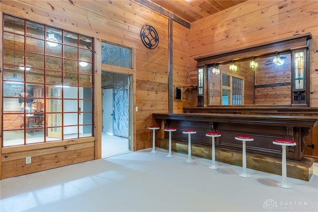 9891 Sugar St, Germantown, OH 45327 - indoor dry bar featuring wooden walls, wood ceiling, and concrete floors