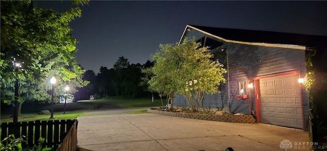 9891 Sugar St, Germantown, OH 45327 - property exterior at night with a garage and driveway