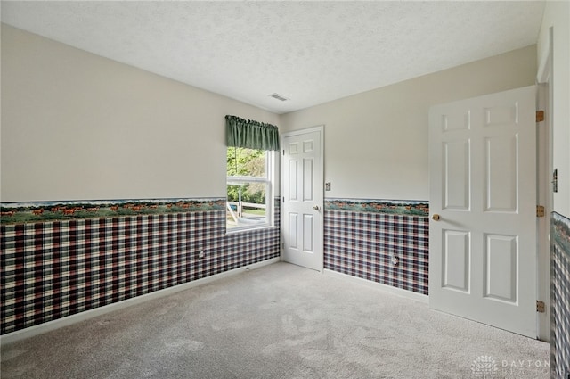 5555 Stone Path Dr, Middletown, OH 45042 - spare room with wainscoting, carpet, and a textured ceiling