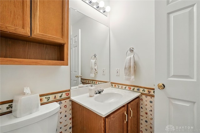 5555 Stone Path Dr, Middletown, OH 45042 - half bath featuring vanity, toilet, and a wainscoted wall