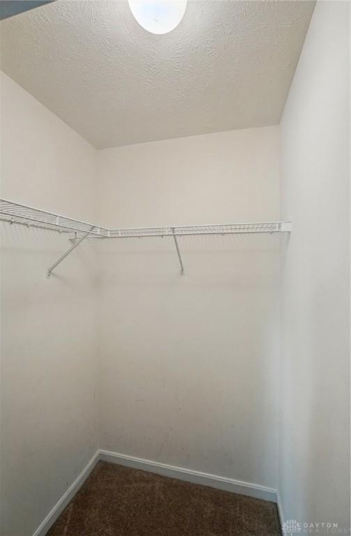 5555 Stone Path Dr, Middletown, OH 45042 - spacious closet featuring dark colored carpet