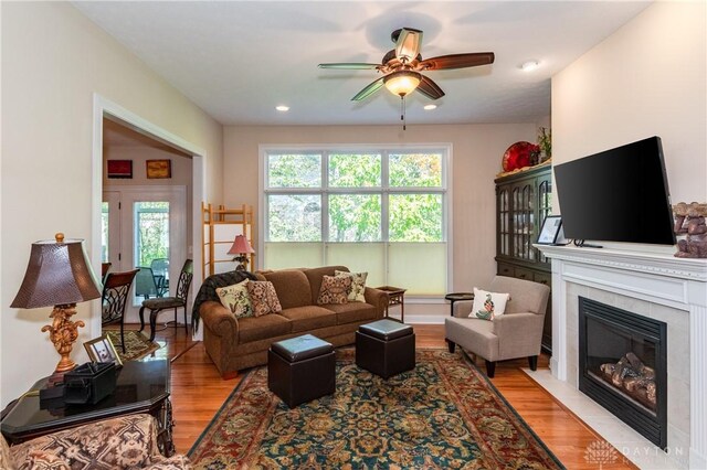 2082 Tamarack Ridge Ct, Beavercreek, OH 45431 - living area with wood finished floors, ceiling fan, a tiled fireplace, and recessed lighting