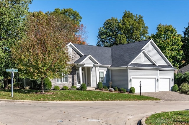 2082 Tamarack Ridge Ct, Beavercreek, OH 45431 - view of front of house with driveway, a garage, a front lawn, and roof with shingles