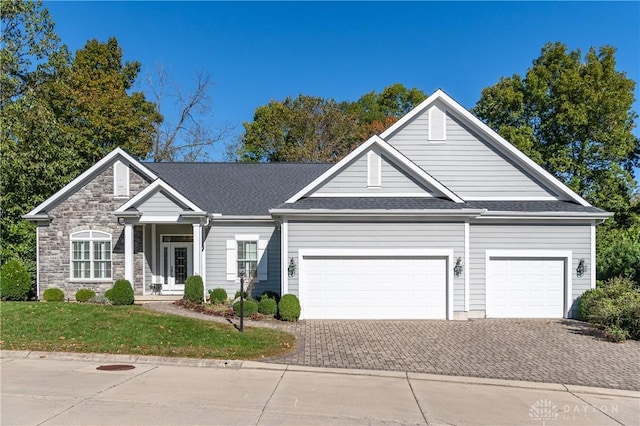 2082 Tamarack Ridge Ct, Beavercreek, OH 45431 - view of front of property with an attached garage, driveway, a front yard, and stone siding