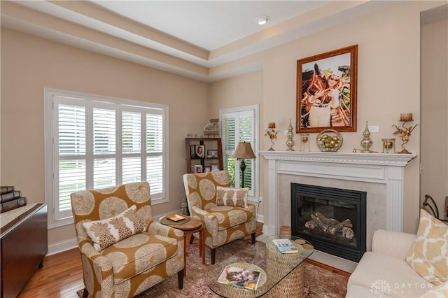 2082 Tamarack Ridge Ct, Beavercreek, OH 45431 - sitting room with plenty of natural light, wood finished floors, a tiled fireplace, and baseboards