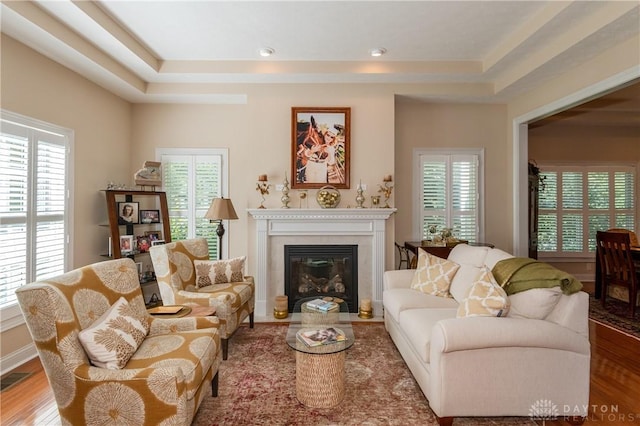 2082 Tamarack Ridge Ct, Beavercreek, OH 45431 - living room with a fireplace with flush hearth, plenty of natural light, a tray ceiling, and wood finished floors