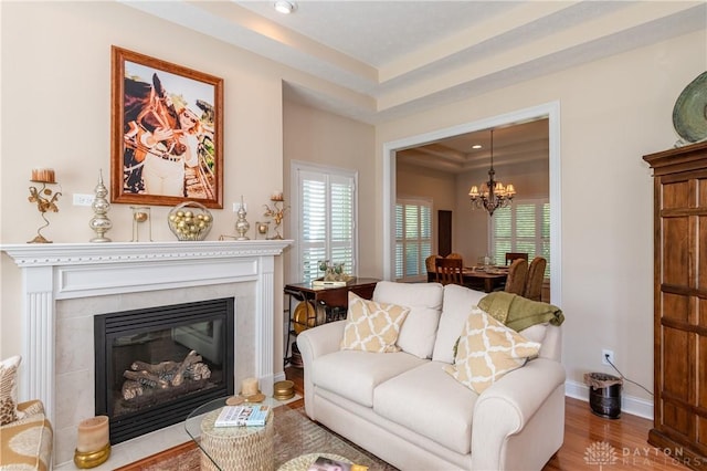 2082 Tamarack Ridge Ct, Beavercreek, OH 45431 - living room with a chandelier, wood finished floors, a tiled fireplace, and recessed lighting