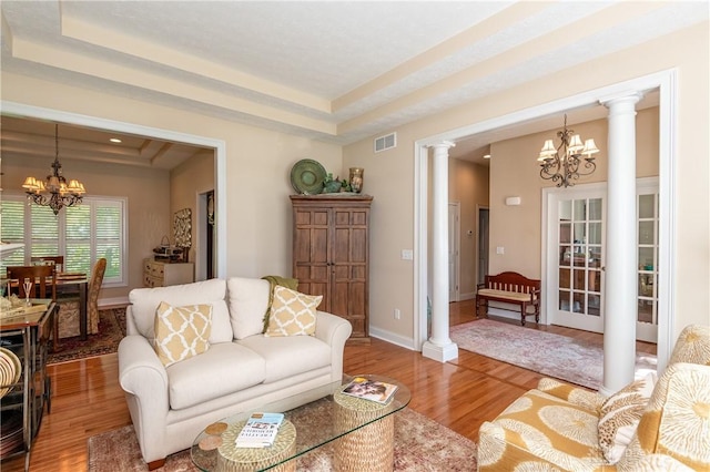 2082 Tamarack Ridge Ct, Beavercreek, OH 45431 - living room with a chandelier, a tray ceiling, and wood finished floors