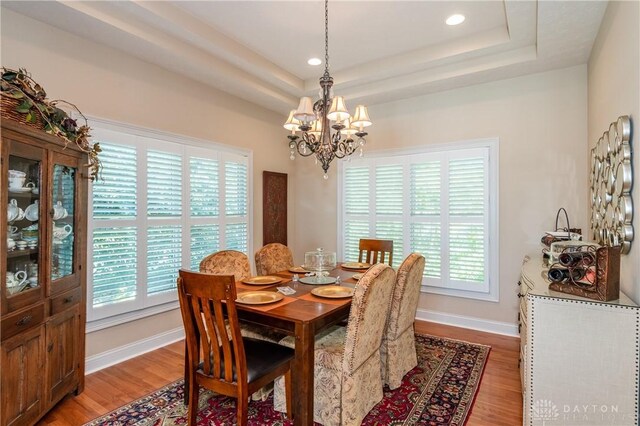 2082 Tamarack Ridge Ct, Beavercreek, OH 45431 - dining room featuring a chandelier, light wood-style floors, a raised ceiling, plenty of natural light, and recessed lighting