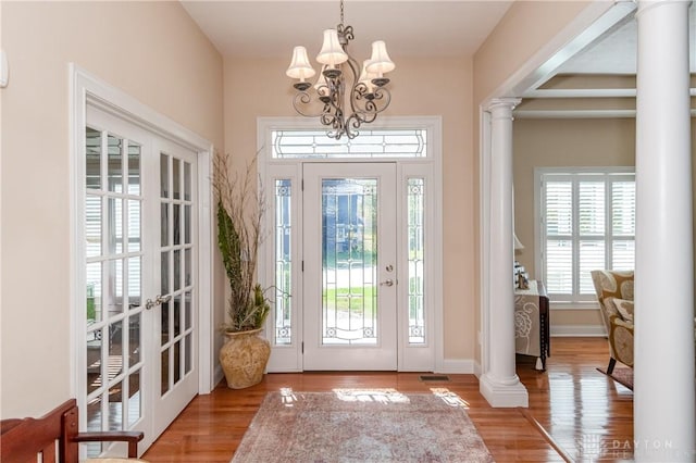 2082 Tamarack Ridge Ct, Beavercreek, OH 45431 - foyer featuring ornate columns, a chandelier, and wood finished floors