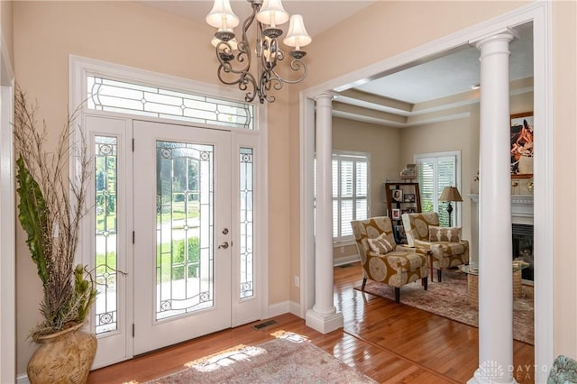 2082 Tamarack Ridge Ct, Beavercreek, OH 45431 - foyer entrance with ornate columns, a chandelier, and wood finished floors