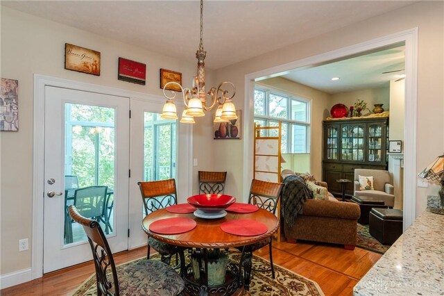 2082 Tamarack Ridge Ct, Beavercreek, OH 45431 - dining room featuring light wood finished floors and a chandelier