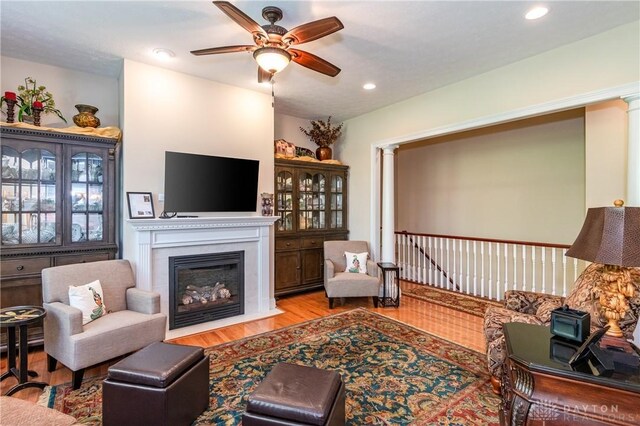 2082 Tamarack Ridge Ct, Beavercreek, OH 45431 - living area with a ceiling fan, wood finished floors, a fireplace with flush hearth, and recessed lighting
