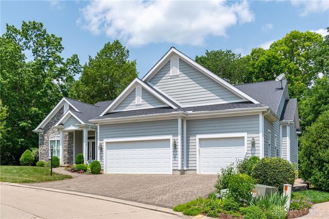 2082 Tamarack Ridge Ct, Beavercreek, OH 45431 - view of front of house featuring an attached garage, decorative driveway, and a shingled roof