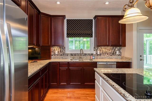 2082 Tamarack Ridge Ct, Beavercreek, OH 45431 - kitchen with stainless steel appliances, light wood finished floors, tasteful backsplash, light stone counters, and recessed lighting