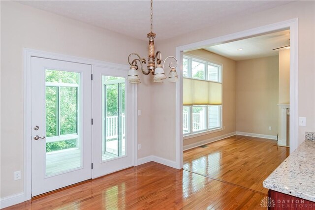 2082 Tamarack Ridge Ct, Beavercreek, OH 45431 - unfurnished dining area with a chandelier and light wood finished floors