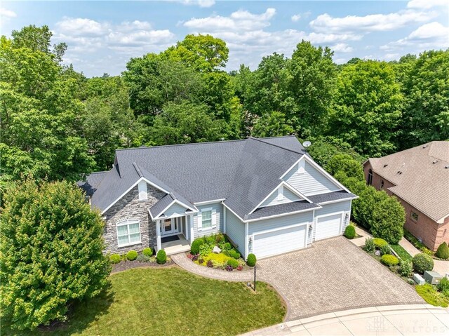2082 Tamarack Ridge Ct, Beavercreek, OH 45431 - view of front of property with a garage, driveway, stone siding, a front lawn, and roof with shingles