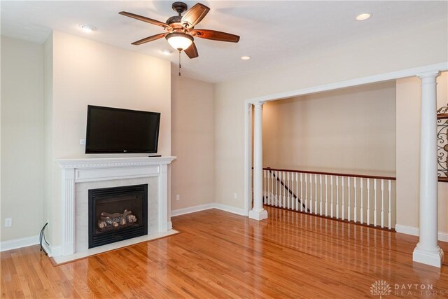 2082 Tamarack Ridge Ct, Beavercreek, OH 45431 - unfurnished living room with a ceiling fan, wood finished floors, a fireplace with flush hearth, and recessed lighting