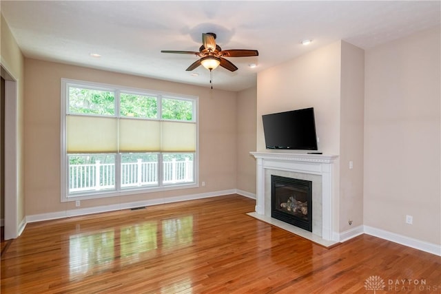 2082 Tamarack Ridge Ct, Beavercreek, OH 45431 - unfurnished living room featuring a fireplace with flush hearth, wood finished floors, a ceiling fan, and recessed lighting