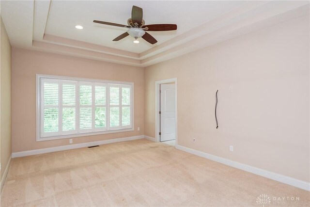 2082 Tamarack Ridge Ct, Beavercreek, OH 45431 - spare room with a tray ceiling, ceiling fan, light carpet, and recessed lighting