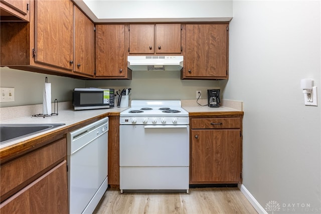 2225 Coach Dr Unit 29A, Kettering, OH 45440 - kitchen featuring under cabinet range hood, white appliances, light wood-style floors, and brown cabinets