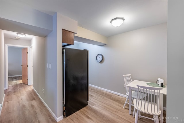 2225 Coach Dr Unit 29A, Kettering, OH 45440 - kitchen featuring freestanding refrigerator, light wood-type flooring, and baseboards