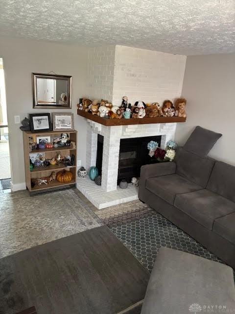 8722 Washington Colony Dr, Dayton, OH 45458 - living room featuring a brick fireplace, a textured ceiling, and wood finished floors