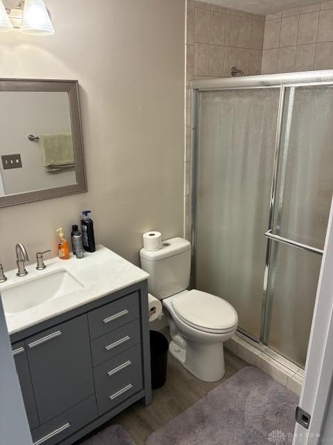 8722 Washington Colony Dr, Dayton, OH 45458 - bathroom featuring vanity, a stall shower, and wood finished floors