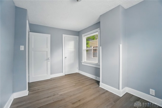 123 Delaware Ave, Dayton, OH 45405 - unfurnished bedroom featuring wood finished floors and a textured ceiling