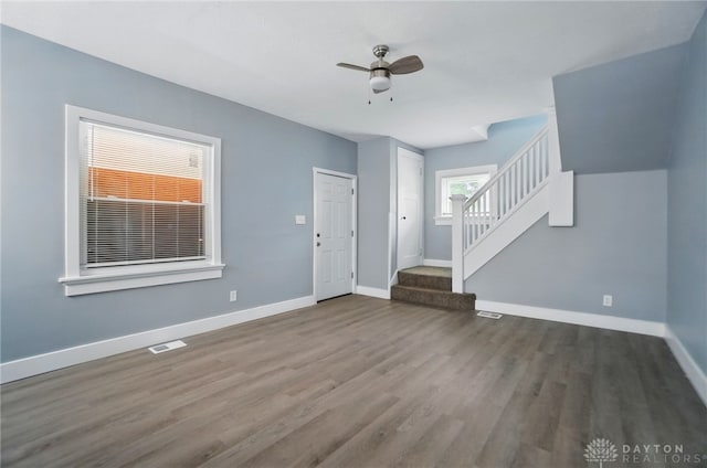 123 Delaware Ave, Dayton, OH 45405 - unfurnished living room with wood finished floors, stairway, and ceiling fan