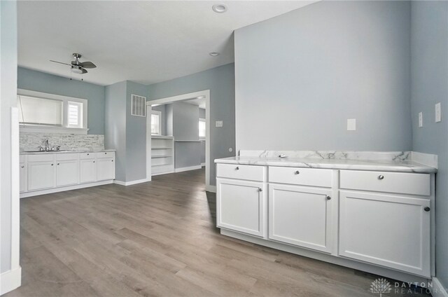 123 Delaware Ave, Dayton, OH 45405 - kitchen featuring ceiling fan, white cabinets, light wood-type flooring, and tasteful backsplash