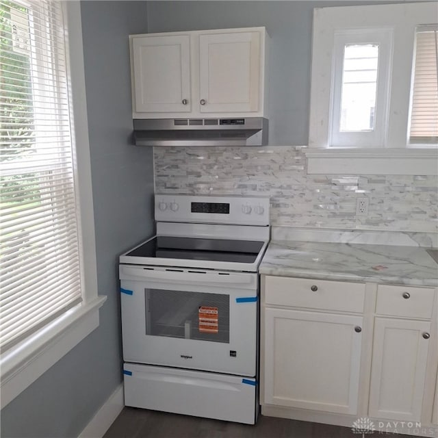 123 Delaware Ave, Dayton, OH 45405 - kitchen with white range with electric cooktop, under cabinet range hood, tasteful backsplash, white cabinets, and light stone counters
