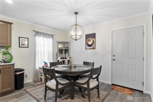 441 Kalynn Cir Unit 26, Fairborn, OH 45324 - dining room featuring light wood-style floors, a chandelier, and crown molding
