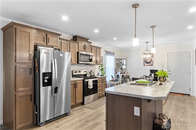 441 Kalynn Cir Unit 26, Fairborn, OH 45324 - kitchen featuring appliances with stainless steel finishes, a kitchen island with sink, light wood-style floors, recessed lighting, and light countertops