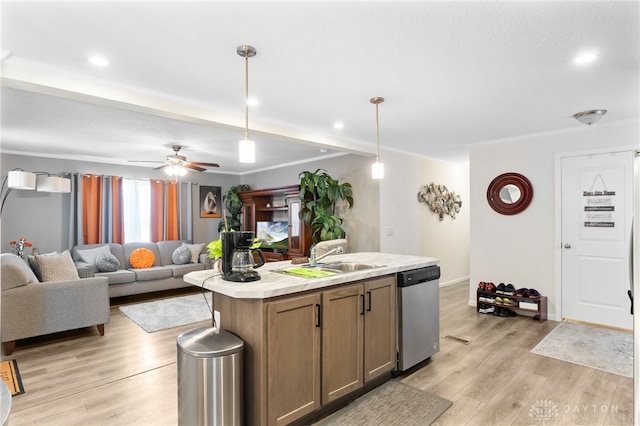 441 Kalynn Cir Unit 26, Fairborn, OH 45324 - kitchen featuring dishwasher, light countertops, light wood-style flooring, hanging light fixtures, and a kitchen island with sink