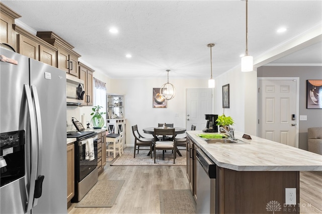 441 Kalynn Cir Unit 26, Fairborn, OH 45324 - kitchen with stainless steel appliances, light countertops, a kitchen island with sink, light wood-style flooring, and recessed lighting